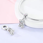 Charm Perrito Plateado con Moño Rosa